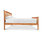 Handcrafted Modern Craftsman bed frame with grid design headboard and footboard by Vermont Furniture Designs, featuring a white mattress and pillows.