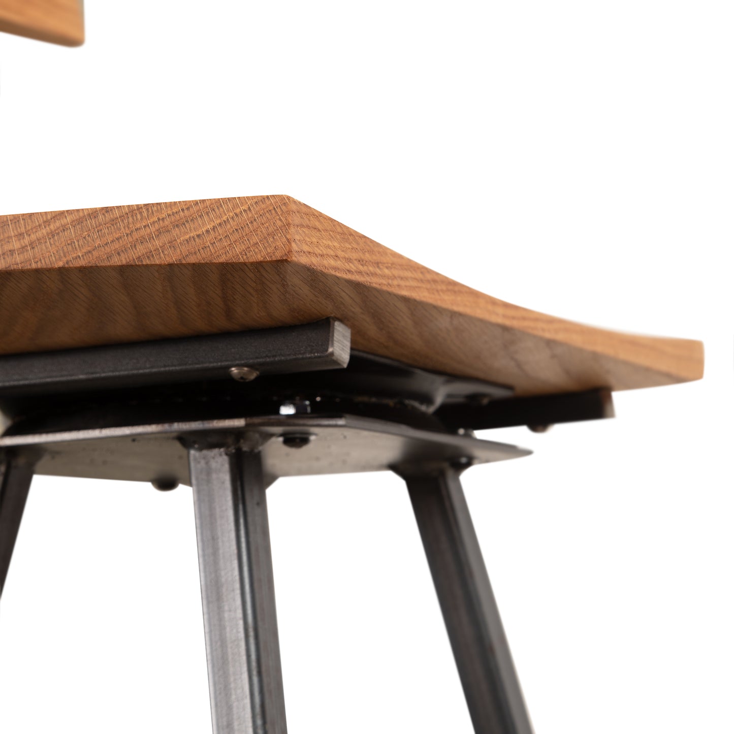 Close-up of the handcrafted oak seat and sturdy metal legs on the Modern Industrial Bar Stool with Back by Vermont Woods Studios.