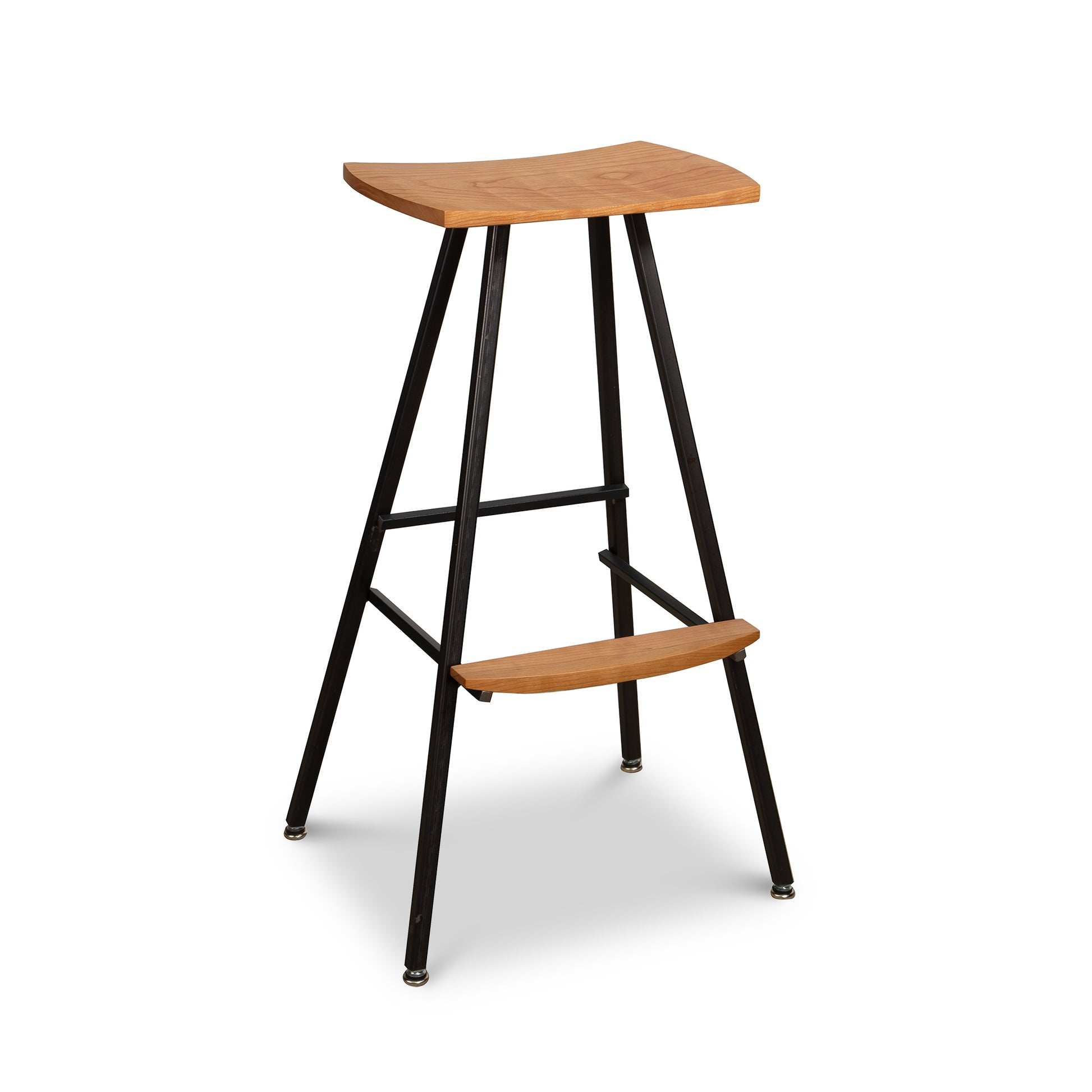 Modern Industrial Bar Stool in Cherry by Vermont Woods Studios with a curved cherry wood seat, sturdy footrest, and black metal legs with crossbars.