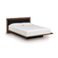 Copeland Moduluxe Platform Bed with Upholstered Headboard, 35" Series, showcasing a sleek wood frame and modern design with white bedding.