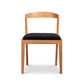 Montgomery Chair by Vermont Woods Studios with cherry frame, curved backrest, and black seat, crafted in America. High quality, modern wooden chair.
