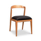 Montgomery Chair by Vermont Woods Studios features a natural cherry frame, elegant curved back, and black seat, highlighting fine American craftsmanship.