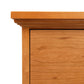 Detail view of Lyndon Furniture New England Shaker 3-Drawer Nightstand showcasing arched base and polished wood finish.