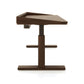 Copeland Furniture Odin Sit-Stand Desk shown from the side, highlighting its modern wooden design, ergonomic features, and central column base.