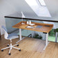 Odin Sit-Stand Desk by Copeland Furniture with a white chair, showcasing premium American craftsmanship and modern design.
