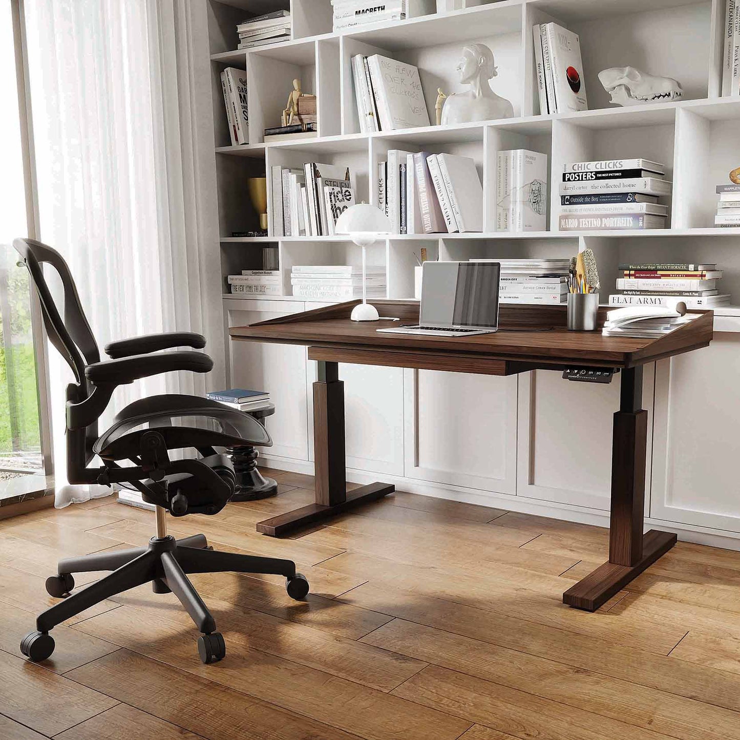 Odin Sit-Stand Desk by Copeland Furniture in a home office, paired with an ergonomic black chair; showcases quality American craftsmanship.
