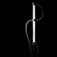 Hubbardton Forge Pulse Floor Lamp featuring a sleek black curving frame, highlighting its tall, modern LED design.