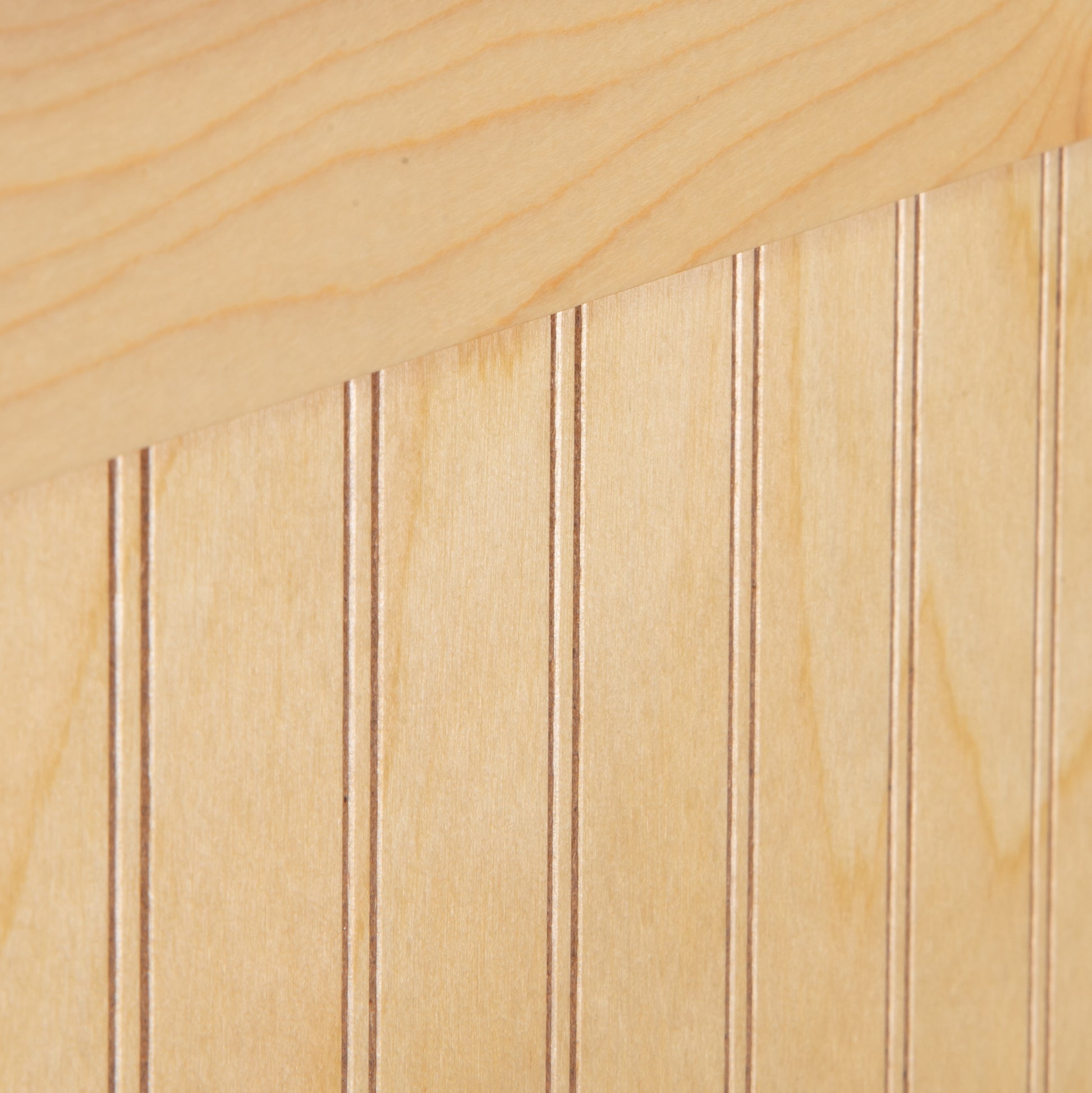 Rockingham Bed by Vermont Woods Studios, showcasing light wood panels with vertical grooves and distinctive diagonal top seam.