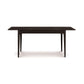 Copeland Furniture Sarah Shaker Tapered Leg Extension Table in dark wood, highlighting its classic design and elegant tapered legs.