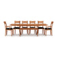 Copeland Furniture Sarah Shaker Trestle Extension Table with eight matching chairs featuring black cushions, showcasing fine American craftsmanship.