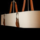 Saratoga Oval Pendant by Hubbardton Forge showcasing beige fabric and brown leather design with silver hardware.