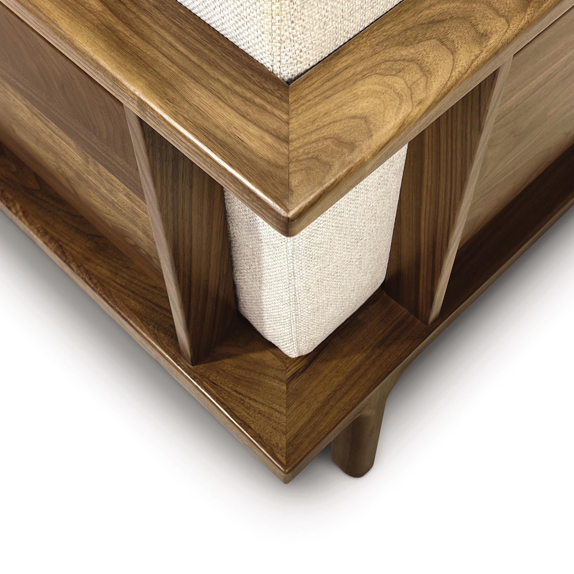 Rich brown wood table corner with beige insert, expertly crafted by Copeland Furniture.