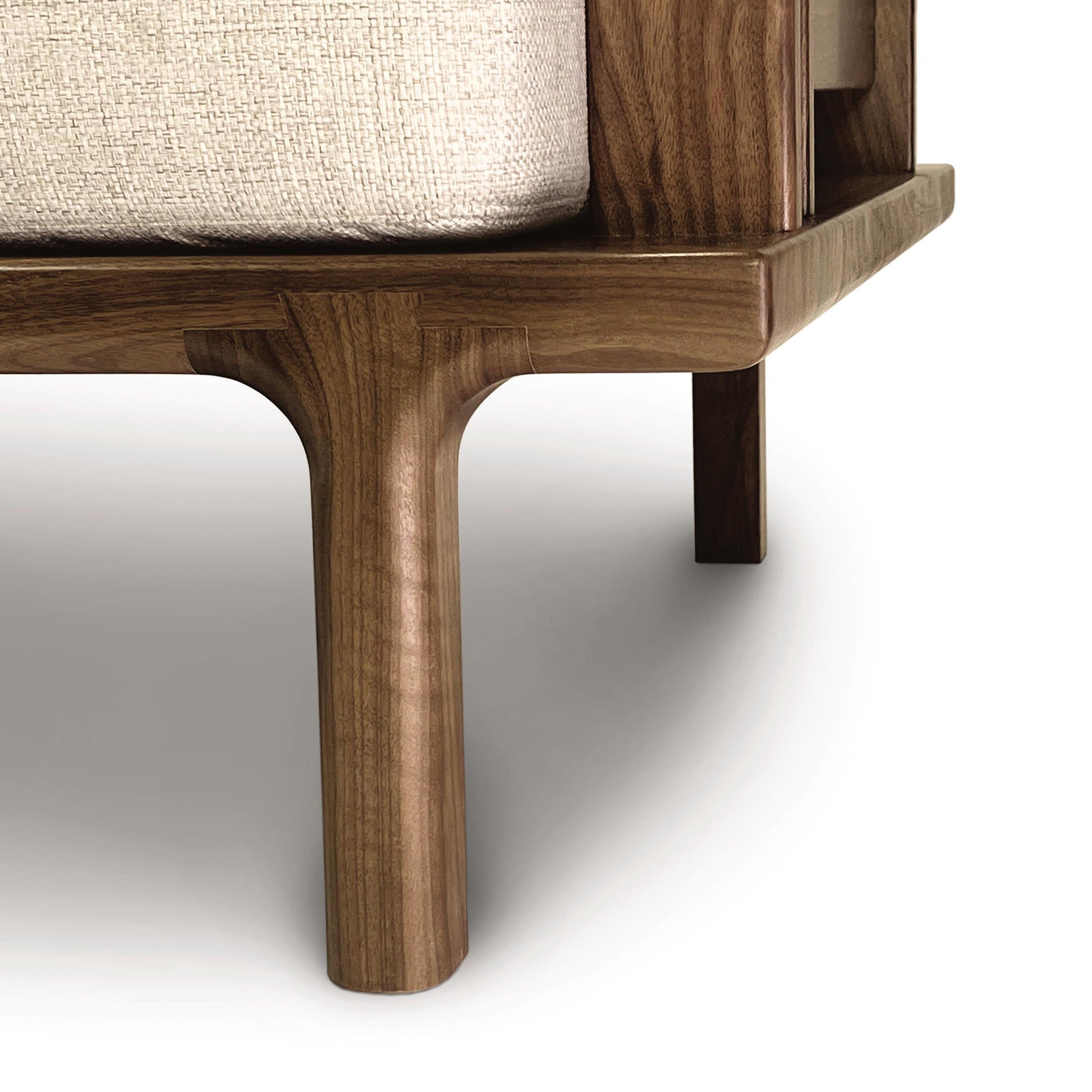 Handcrafted wooden frame with rounded legs supporting light fabric, showcasing the elegance of a Copeland Furniture Sierra Upholstered Sofa.