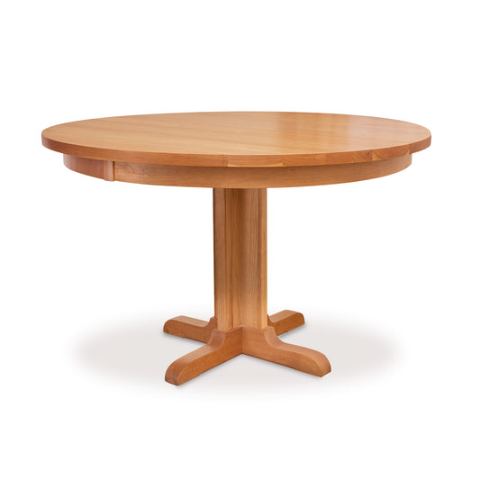 Lyndon Furniture Single-Leg Round Pedestal Table crafted in natural cherry with solid wood top, showcased clearly against a simple white background.