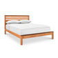 Skyline Panel Bed in queen size by Vermont Furniture Designs, shown in natural cherry with a slatted headboard and crisp white bedding.