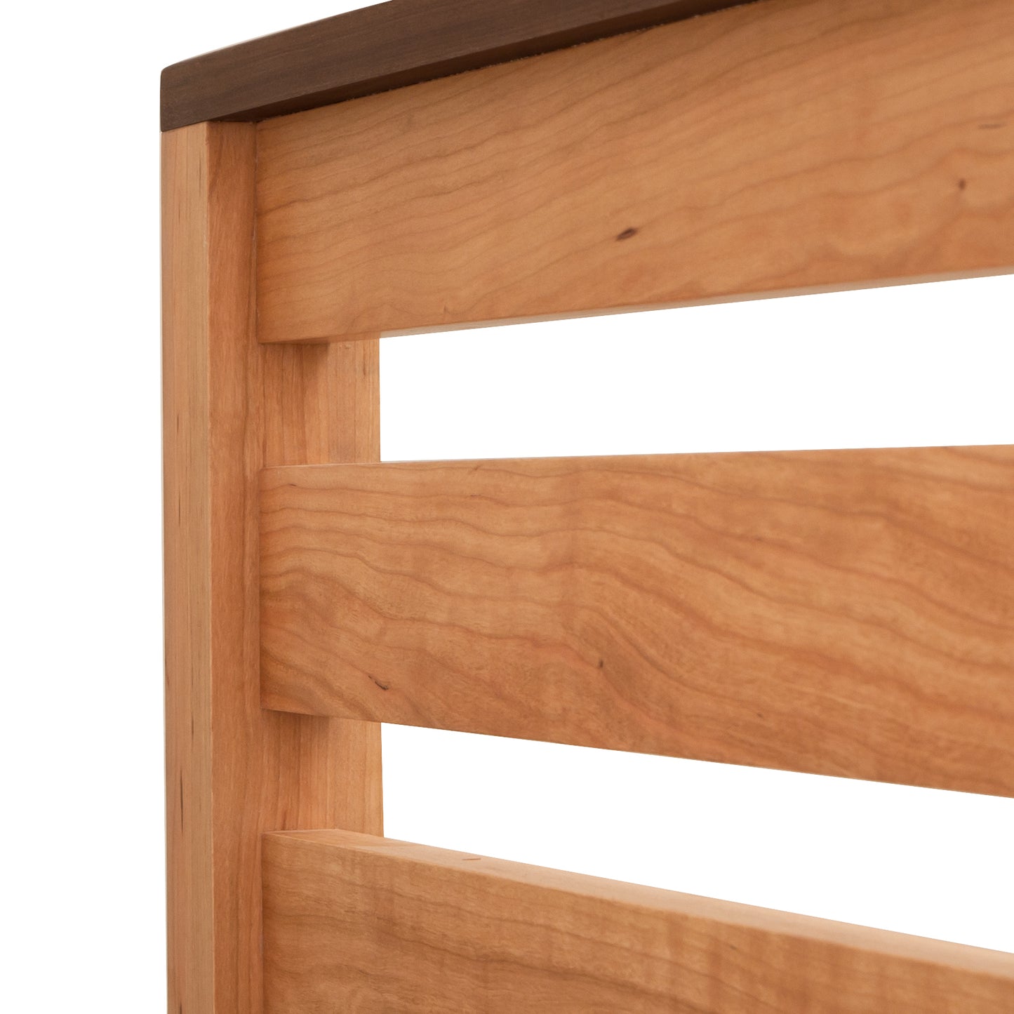 Vermont Furniture Designs Skyline Panel Bed in queen size, crafted from natural cherry wood with a smooth finish showcasing detailed grain.