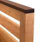 Vermont Furniture Designs Skyline Panel Bed queen headboard in natural cherry, featuring vertical slats and a contrasting dark top rail.