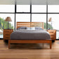 Skyline Panel Bed by Vermont Furniture Designs with gray bedding and wooden nightstands.