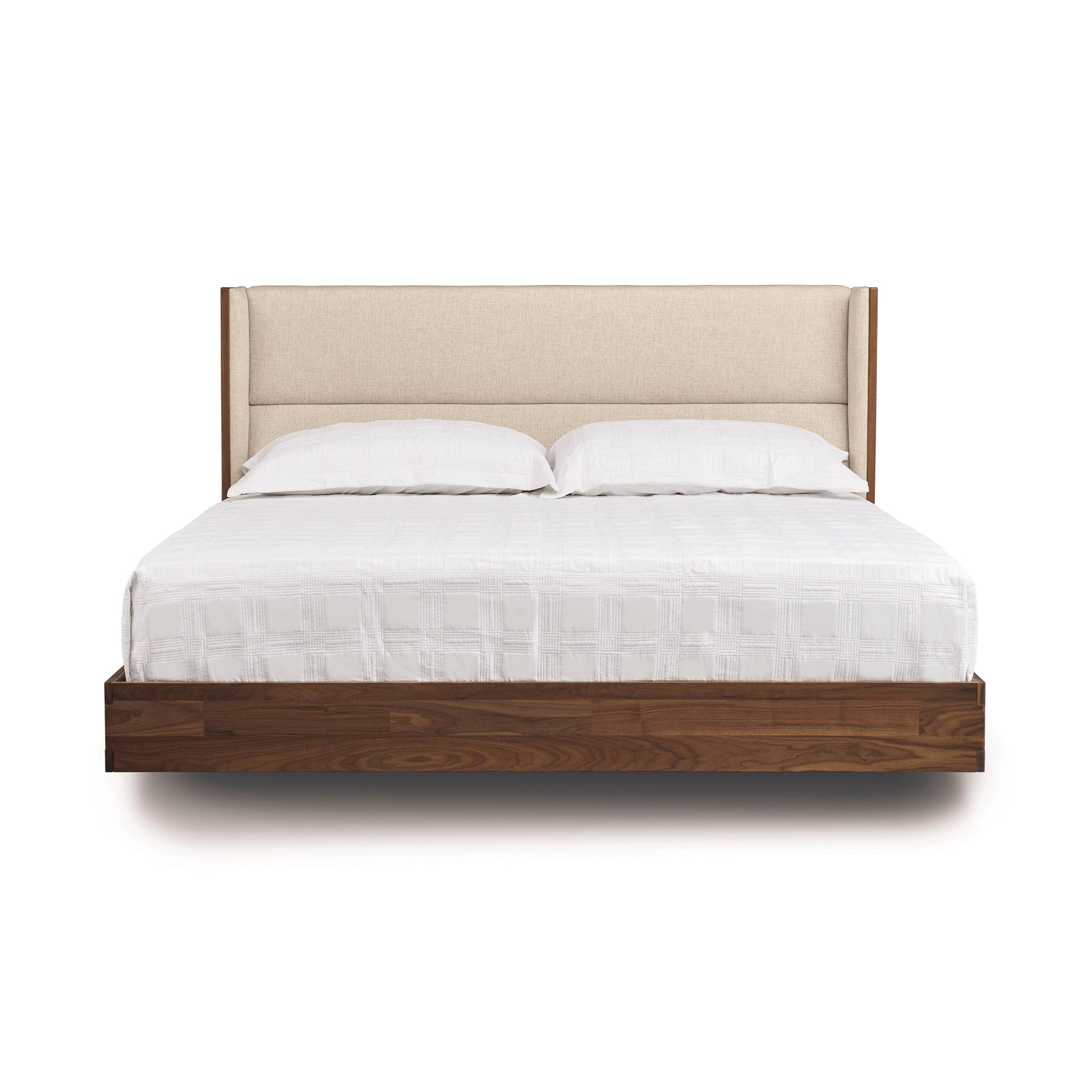 Sloane Floating Bed by Copeland Furniture with a beige upholstered headboard and white bedding, showcasing its modern, minimalist design.