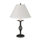 Twist Basket Table Lamp by Hubbardton Forge with a white shade and distinctive black metal lattice base, showcasing artisanal craftsmanship.