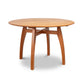 Vermont Modern Round Solid Top Pedestal Table by Lyndon Furniture with four curved legs and natural wood grain.