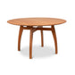 Lyndon Furniture Vermont Modern Round Solid Top Pedestal Table with four curved legs and natural wood grain detailing.