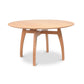 Lyndon Furniture Vermont Modern round pedestal table with solid wood top, light finish, and four elegantly curved legs.