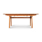 Vermont Modern Butterfly Extension Table by Lyndon Furniture with angled legs and a smooth wood top, highlighting its contemporary design.