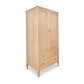 Vermont Shaker Armoire by Maple Corner Woodworks, solid wood with two doors and two drawers with round knobs, standing on four legs.