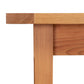 Vermont Shaker Solid Top Harvest Table corner by Maple Corner Woodworks, showcasing traditional style with simple lines and rich natural cherry wood grain texture.
