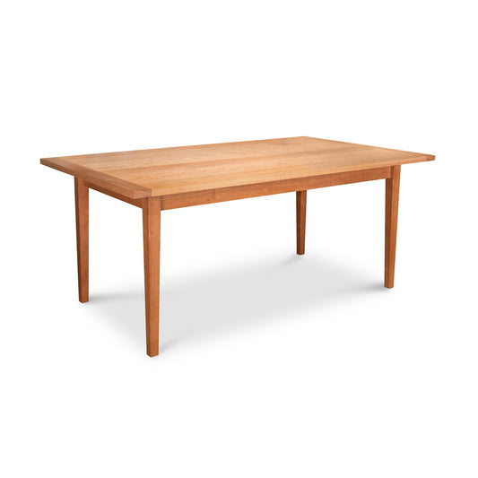 Vermont Shaker Solid Top Harvest Table by Maple Corner Woodworks, crafted in natural cherry with a wooden rectangular design and four tapered legs, showcasing traditional elegance and simplicity.