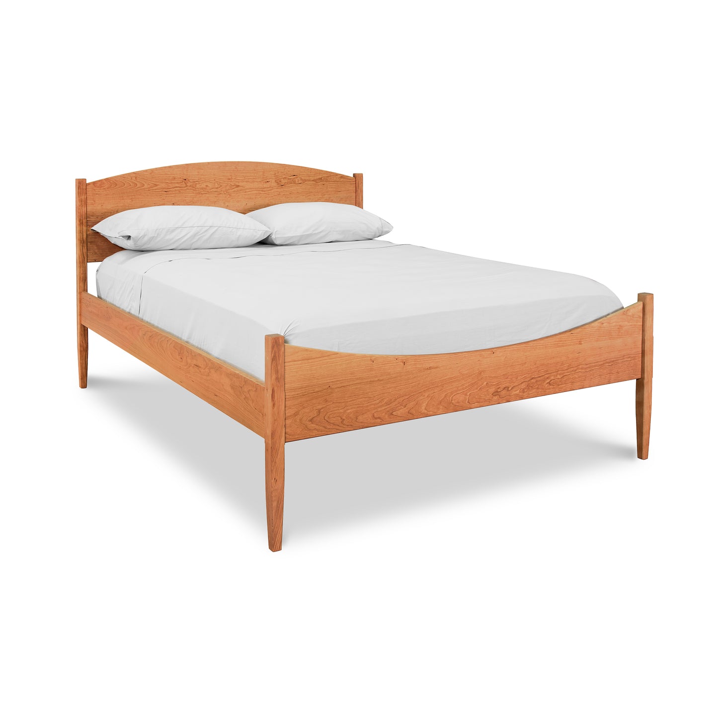 Vermont Shaker Moon Bed by Maple Corner Woodworks with minimalist design and natural wood finish, featuring a white mattress and two pillows.