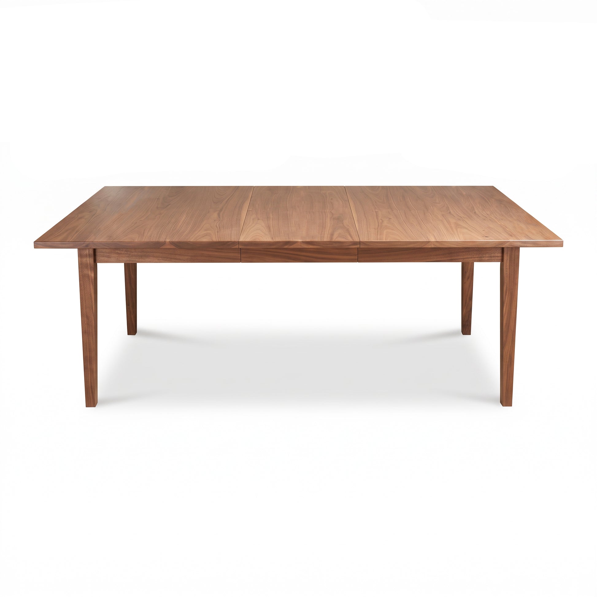 Maple Corner Woodworks Vermont Shaker Rectangular Extension Dining Table with four legs, crafted from solid wood, shown in a simple studio setting.