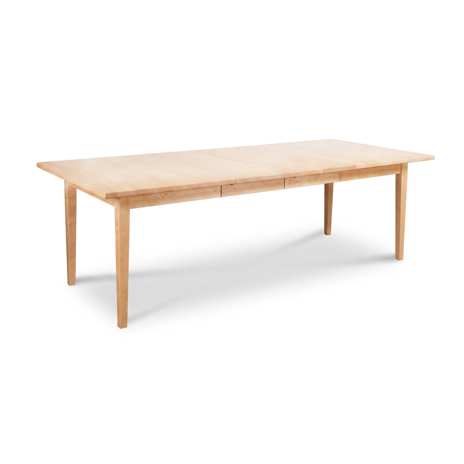 Vermont Shaker Rectangular Extension Dining Table by Maple Corner Woodworks in solid wood with four straight legs and a light natural finish.