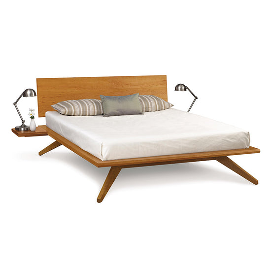 A wooden bed with a wooden headboard and footboard.
