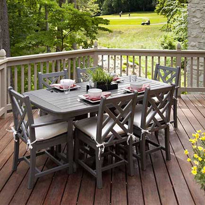 A wooden deck with a table and chairs.