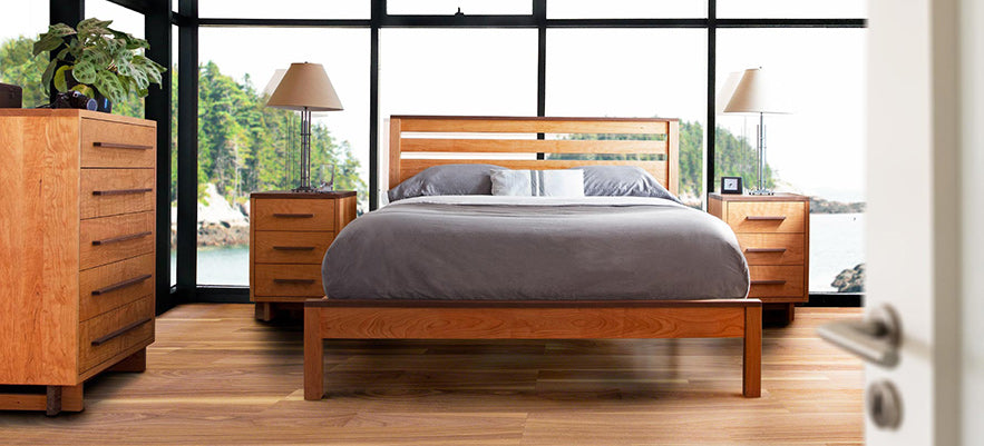 A bedroom with a bed and dresser.