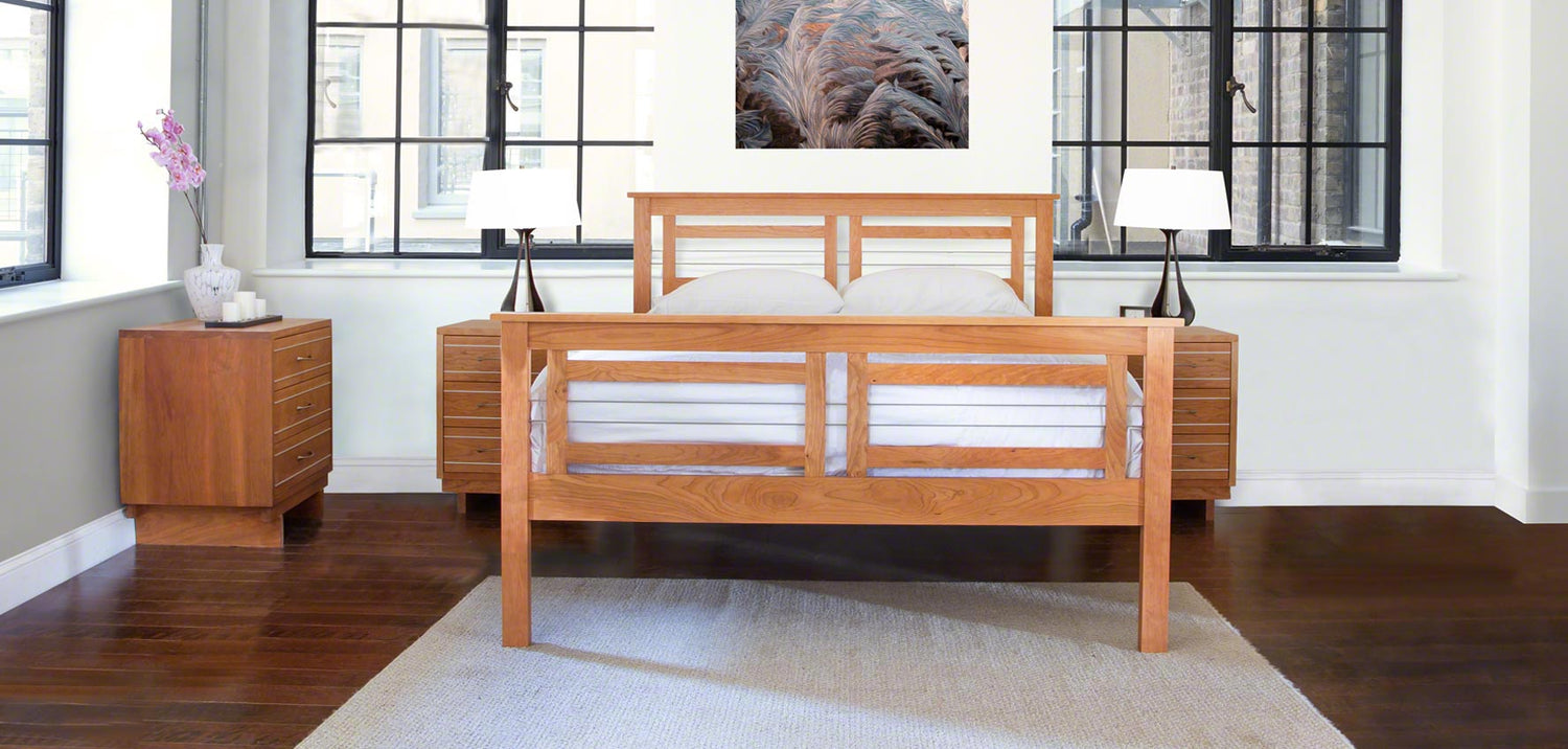 A bedroom with a wooden bed and dresser.