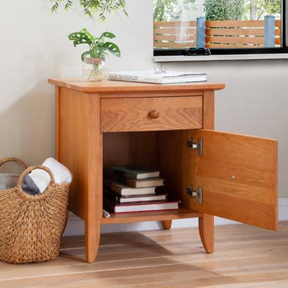 A wooden nightstand with a basket on top.
