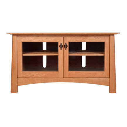 A wooden tv stand with glass doors.