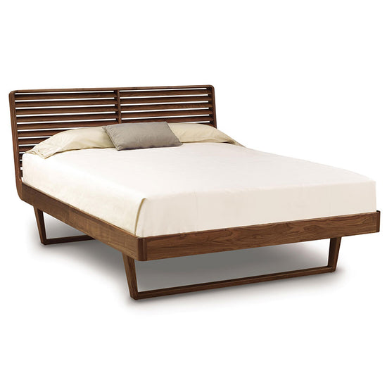 A bed with a wooden frame and slats.