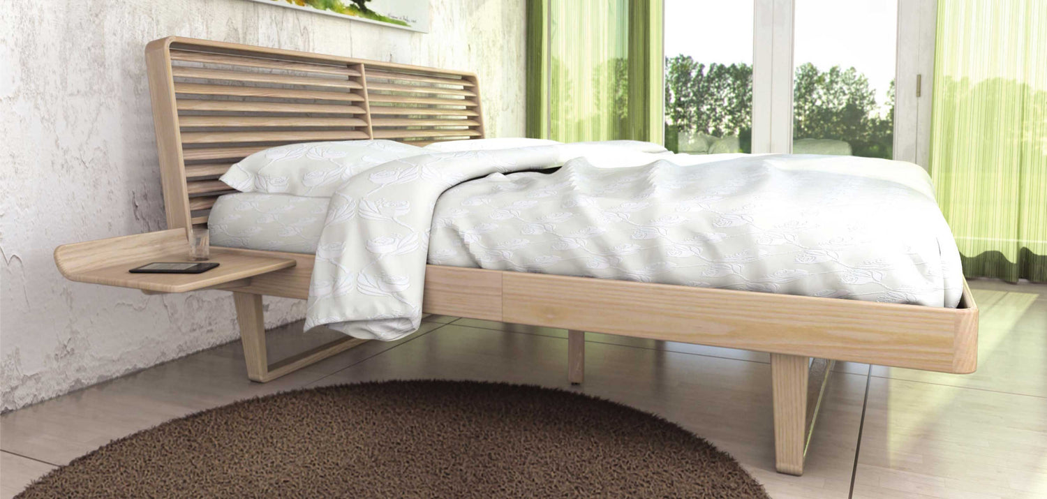 A bed in a room with green curtains.
