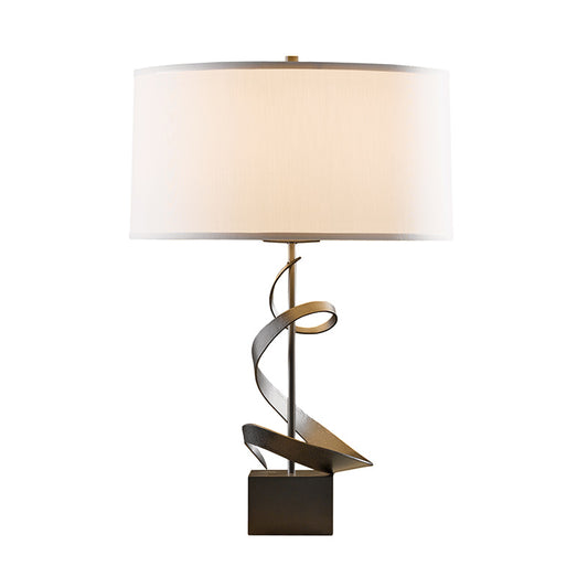 Gallery Spiral Table Lamp by Hubbardton Forge with a twisted metal base, burnished steel finish, and white drum shade. Handcrafted American-made furniture.
