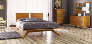 A modern bedroom with a wooden bed and dresser.