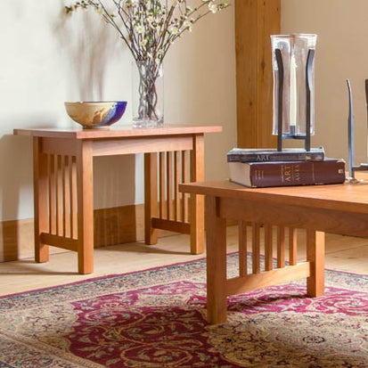 A living room with a coffee table and a vase.