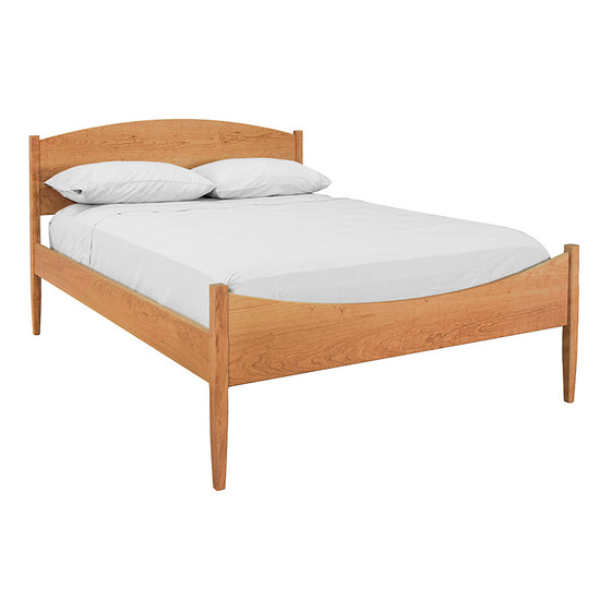 A bed with a wooden frame and white sheets.